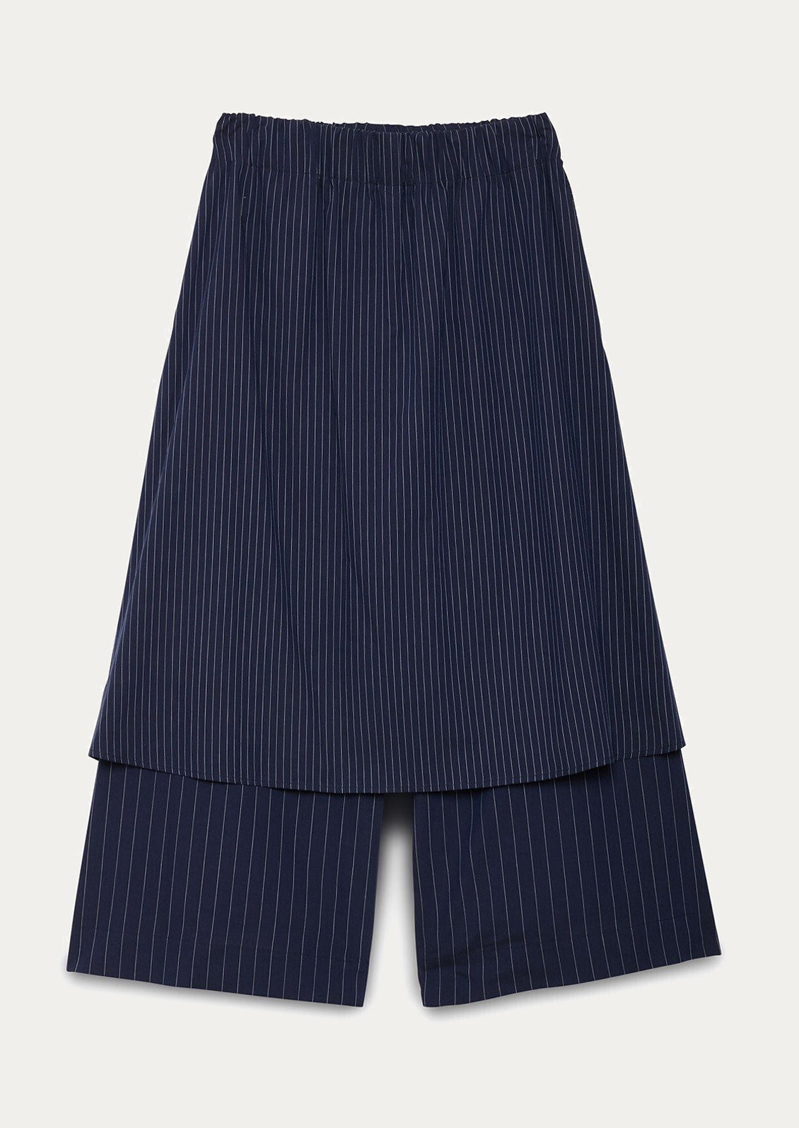 A pair of navy blue pinstripe pants with skirt-like layer over top.