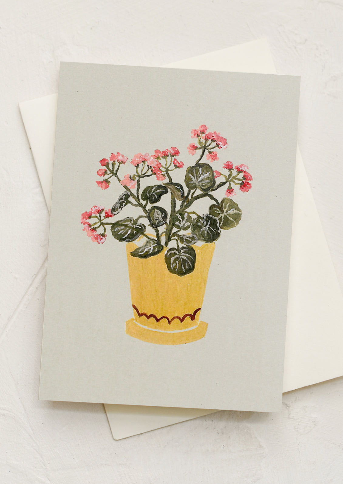 A mini greeting card in mint with illustration of geraniums in pot.