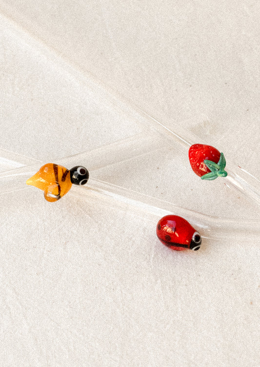 Clear glass straws with bend shape, with assorted figurine detailing.