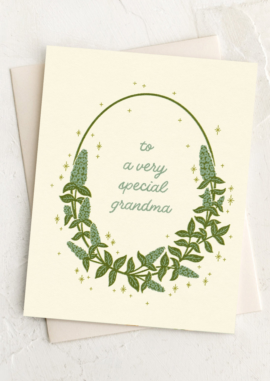 Greeting card with green leaf design and text 'to a very special grandma' on a light background