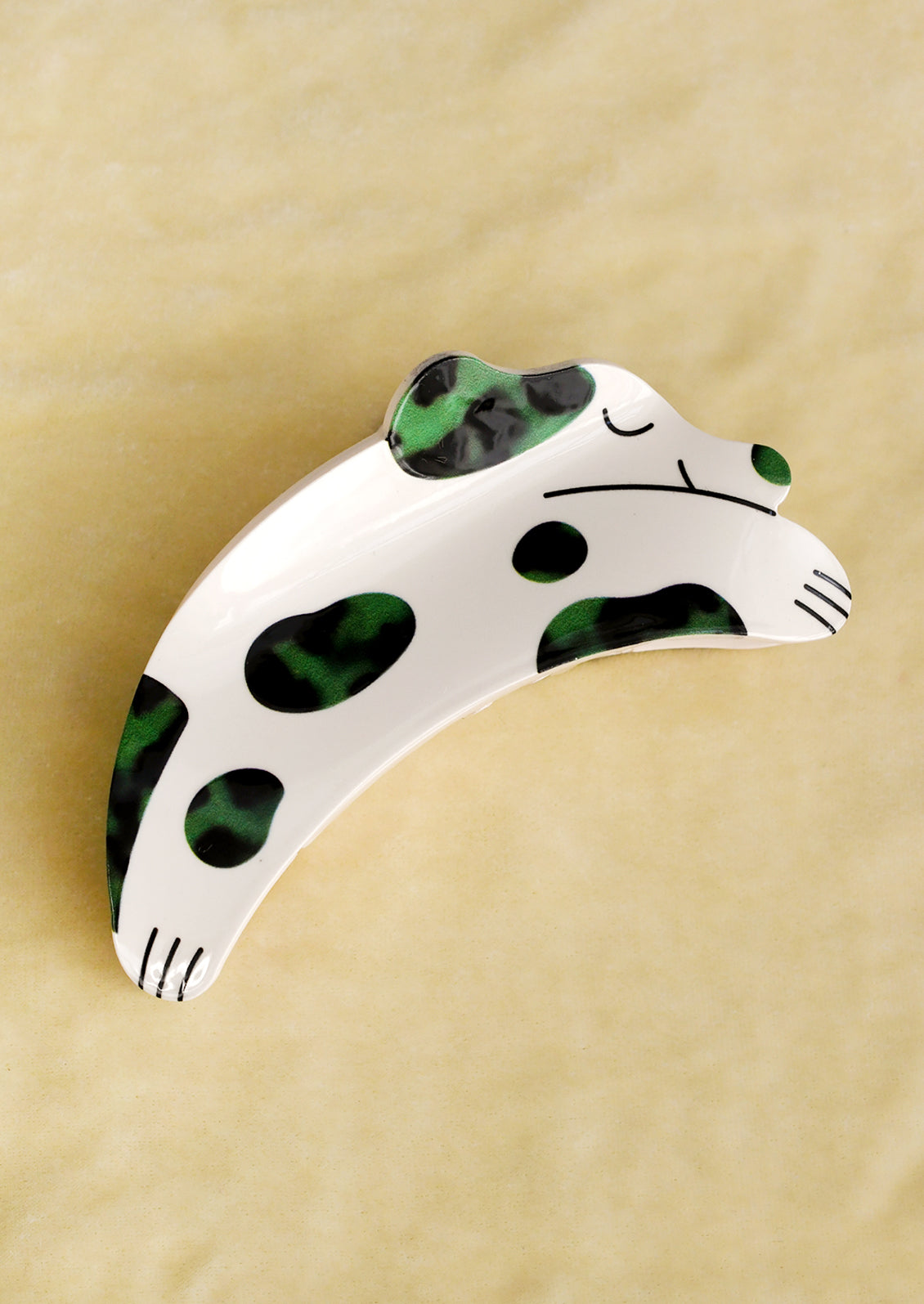 White and green dog-shaped object on a beige background