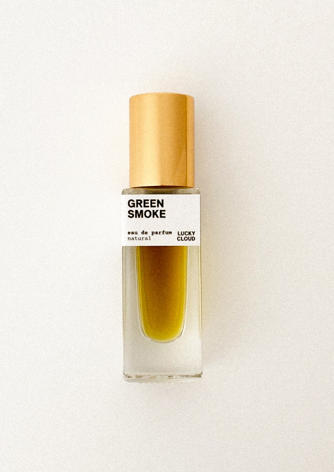 Perfume bottle labeled 'Green Smoke' by Lucky Cloud on a white background