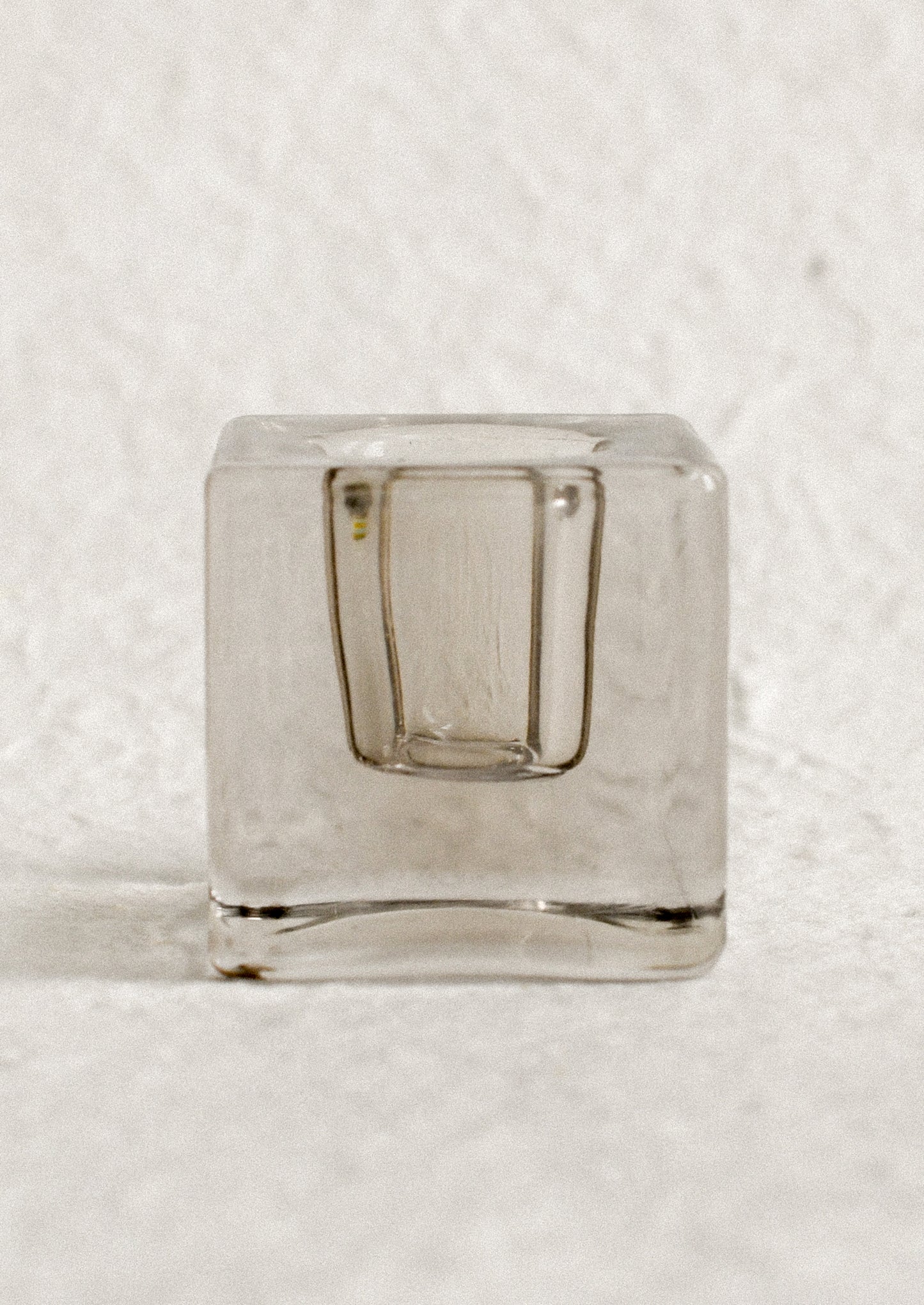 A cube-shaped slab glass candleholder in grey / short.