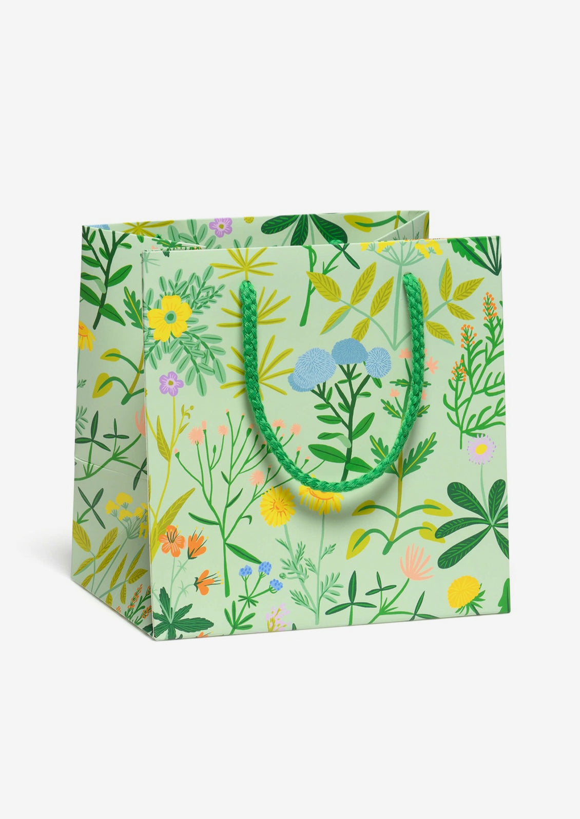 A small square shaped gift bag in mint with multicolor botanical print.