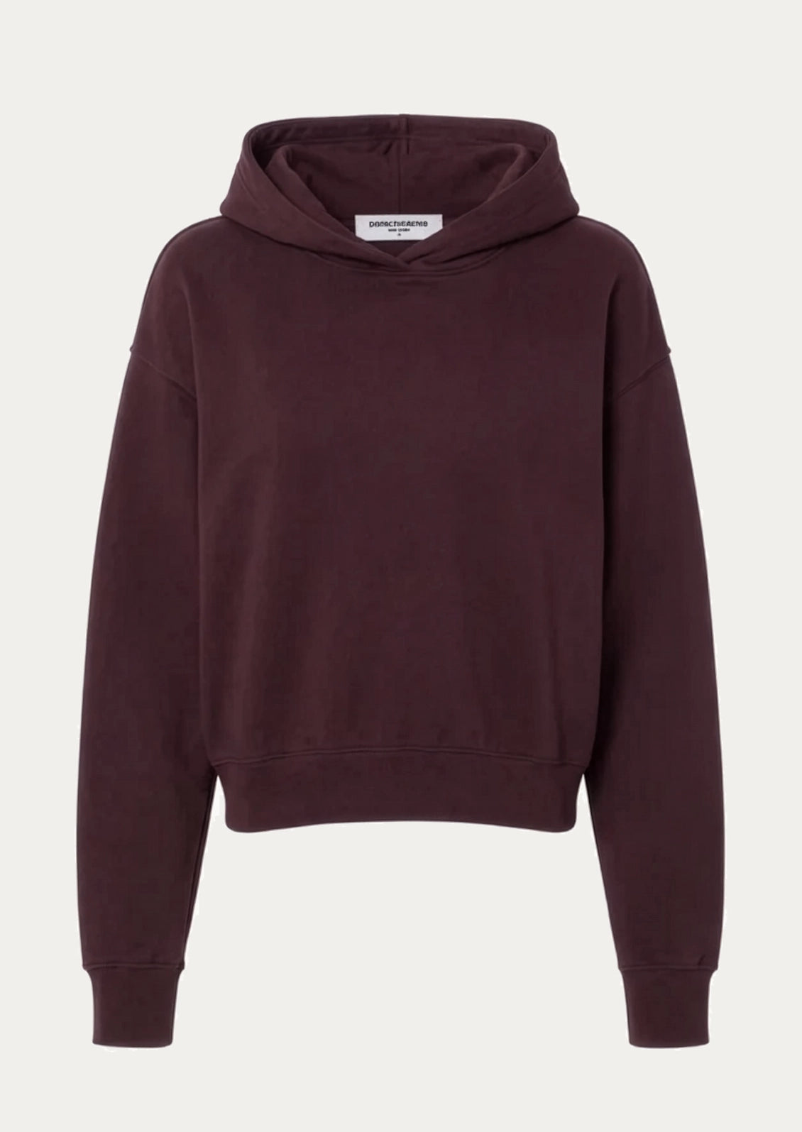 A dark burgundy cropped hoodie sweatshirt with a white brand label on the inside neck, displayed against a light off-white background.