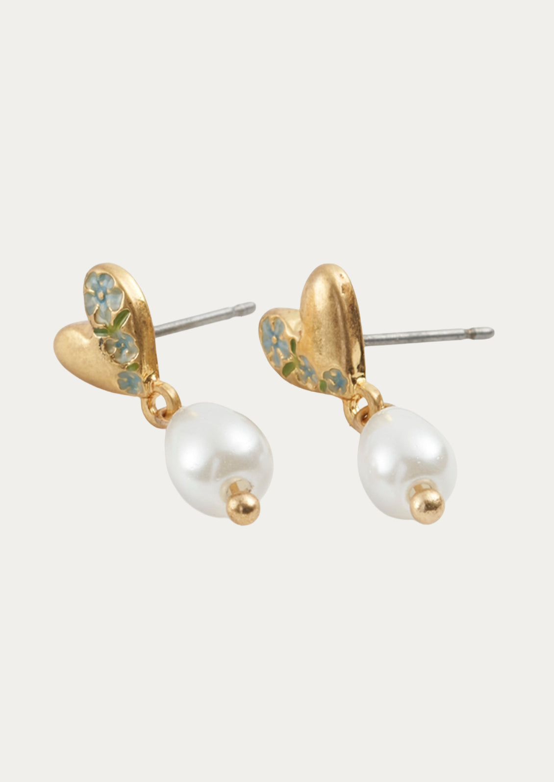 A pair of gold heart shaped earrings with a  dangling pearl.
