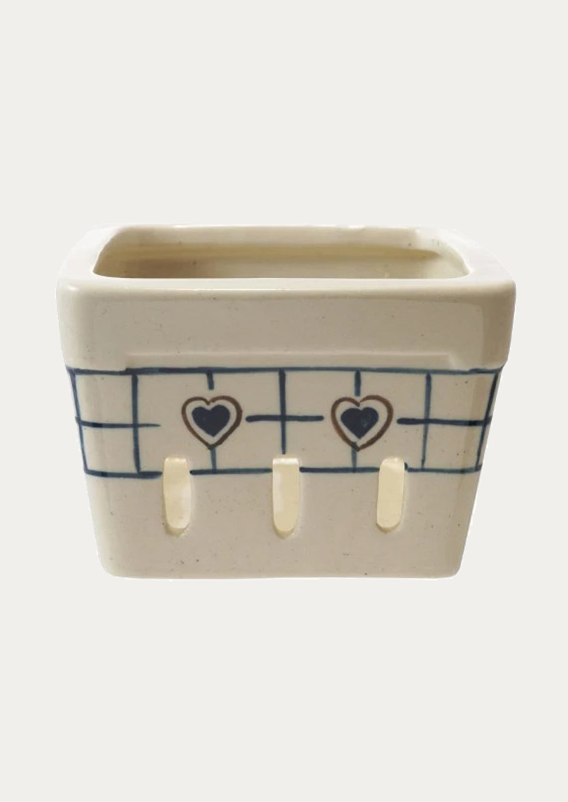 Ceramic berry basket with a heart design.