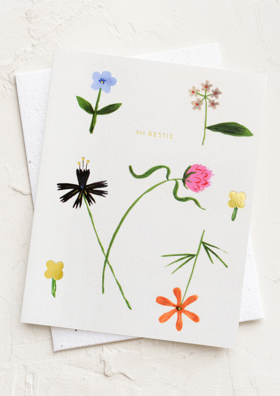 A greeting card with floral print, text reads "Hi bestie".