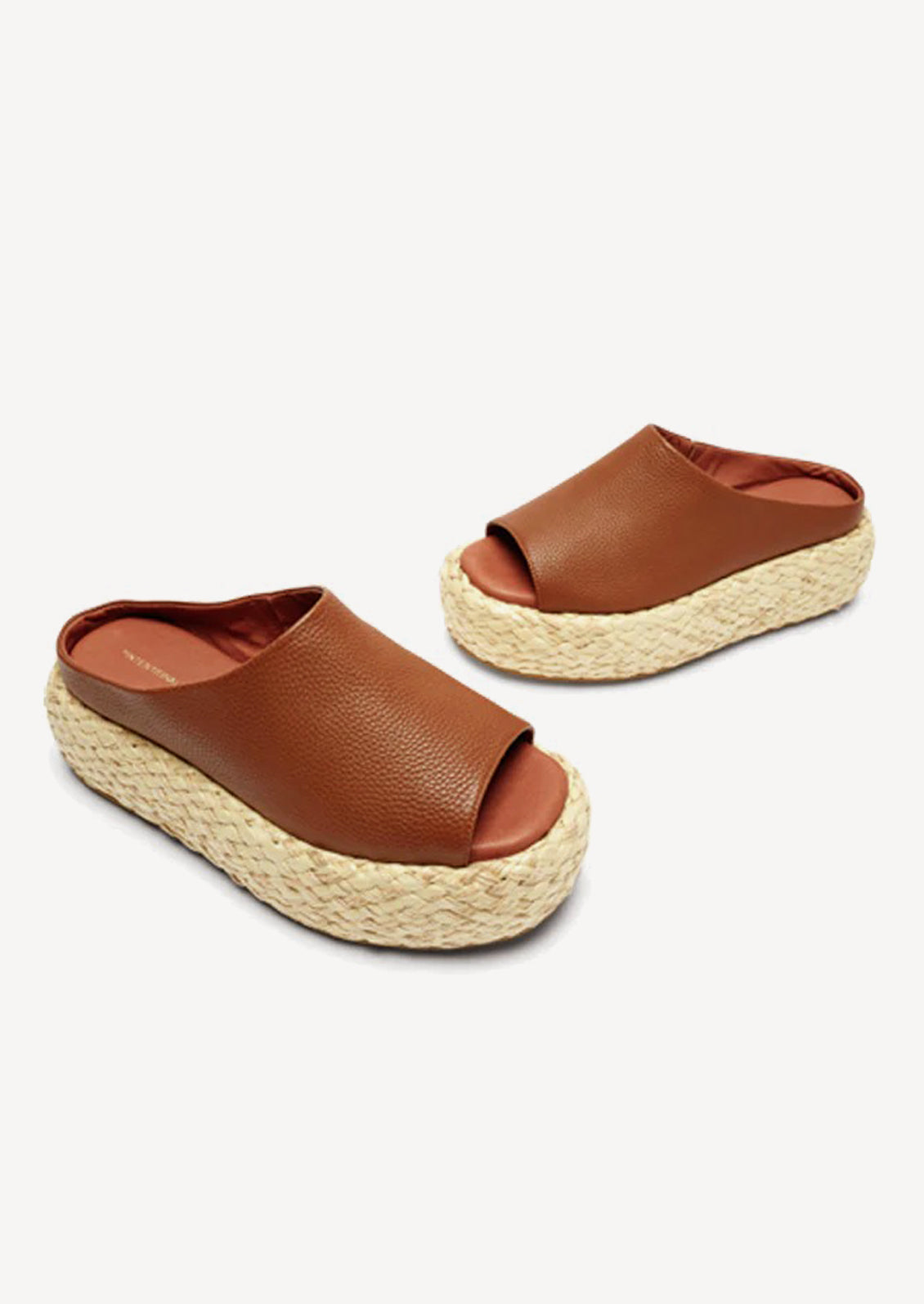 A pair of leather platform sandals with espadrille sole in brown.