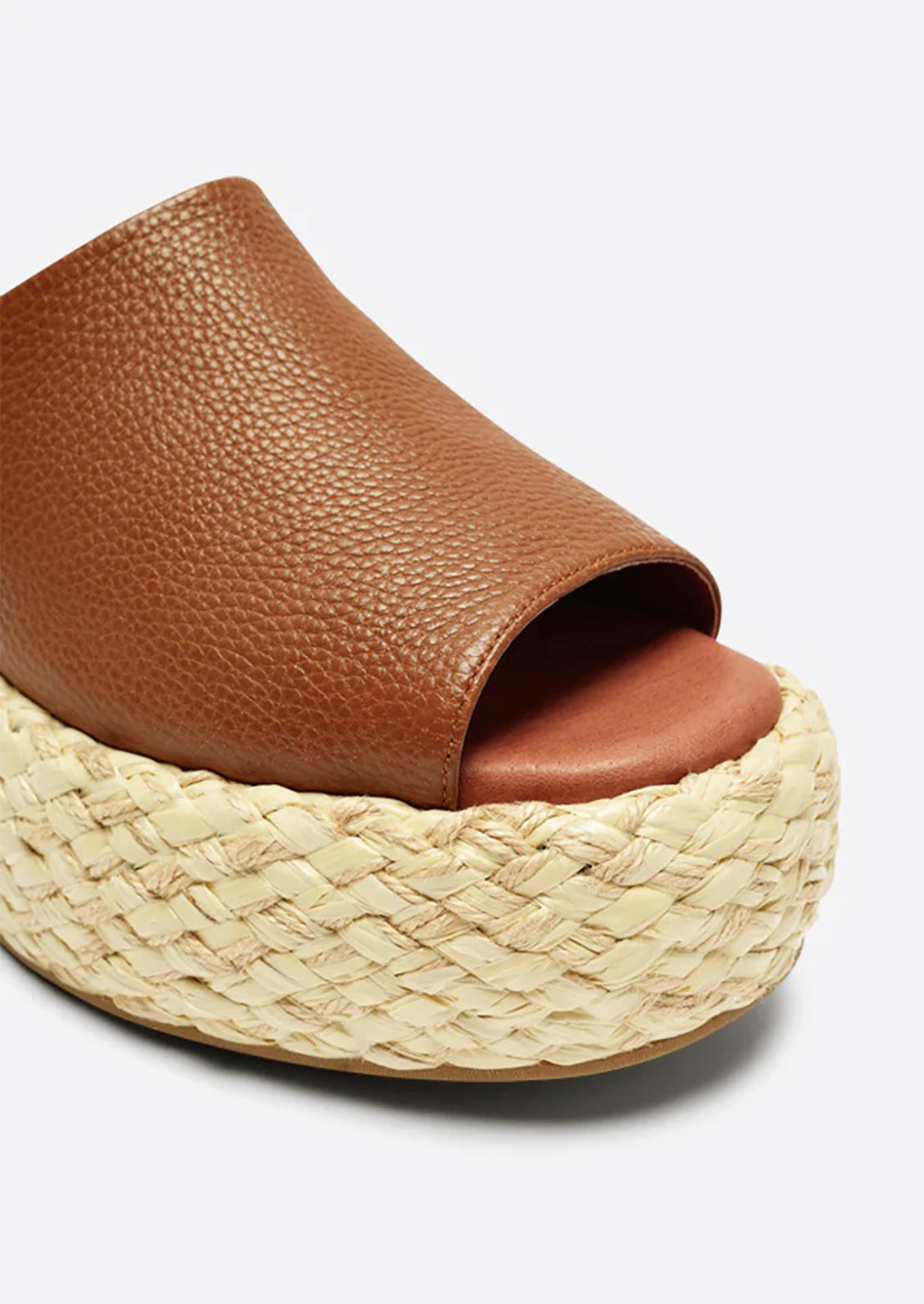 A pair of leather platform sandals with espadrille sole in brown.