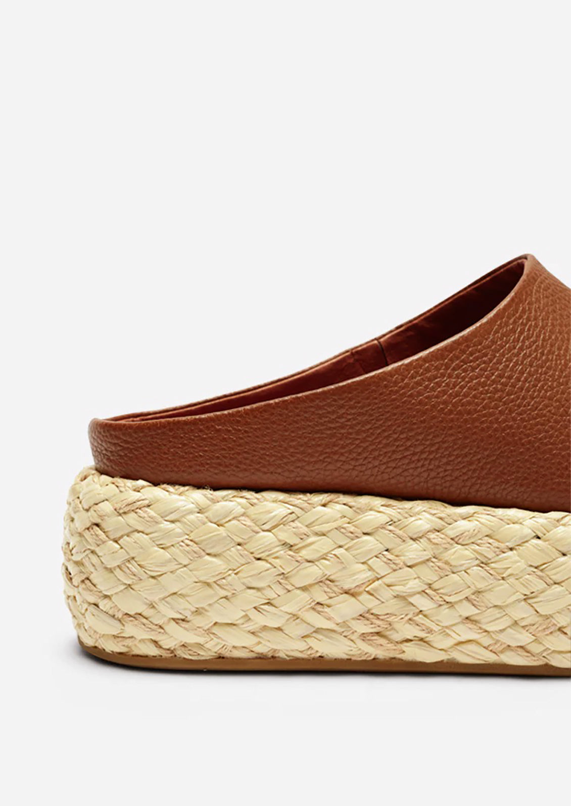 A pair of leather platform sandals with espadrille sole in brown.