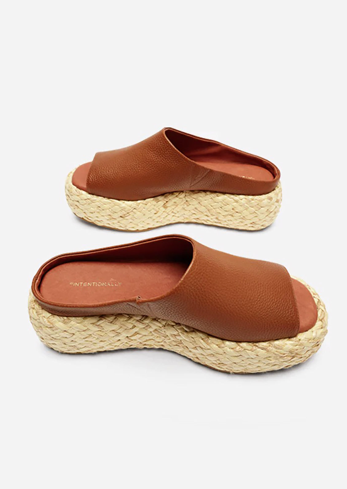 A pair of leather platform sandals with espadrille sole in brown.