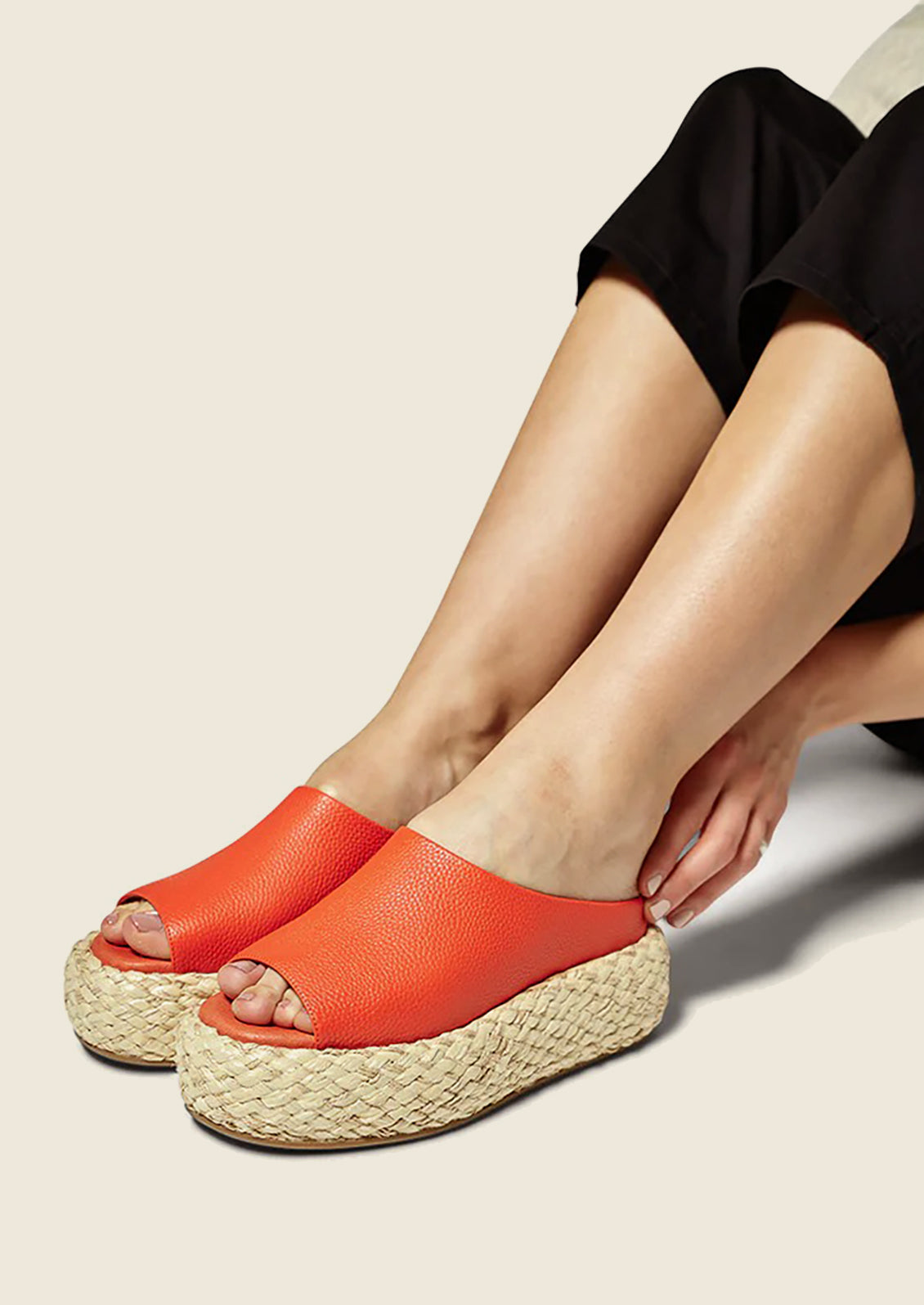 A pair of leather platform sandals with espadrille sole in poppy red-orange.