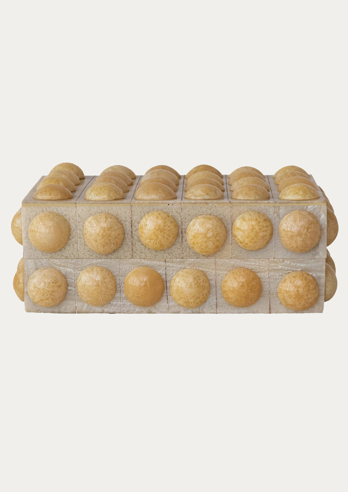 A hobnail textured storage box in cream.