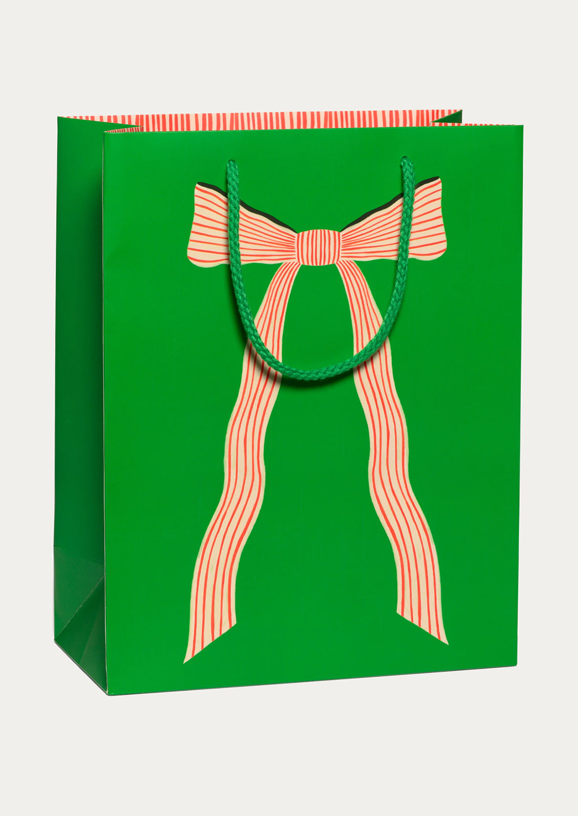 A large green gift bag with image of red and white striped bow.
