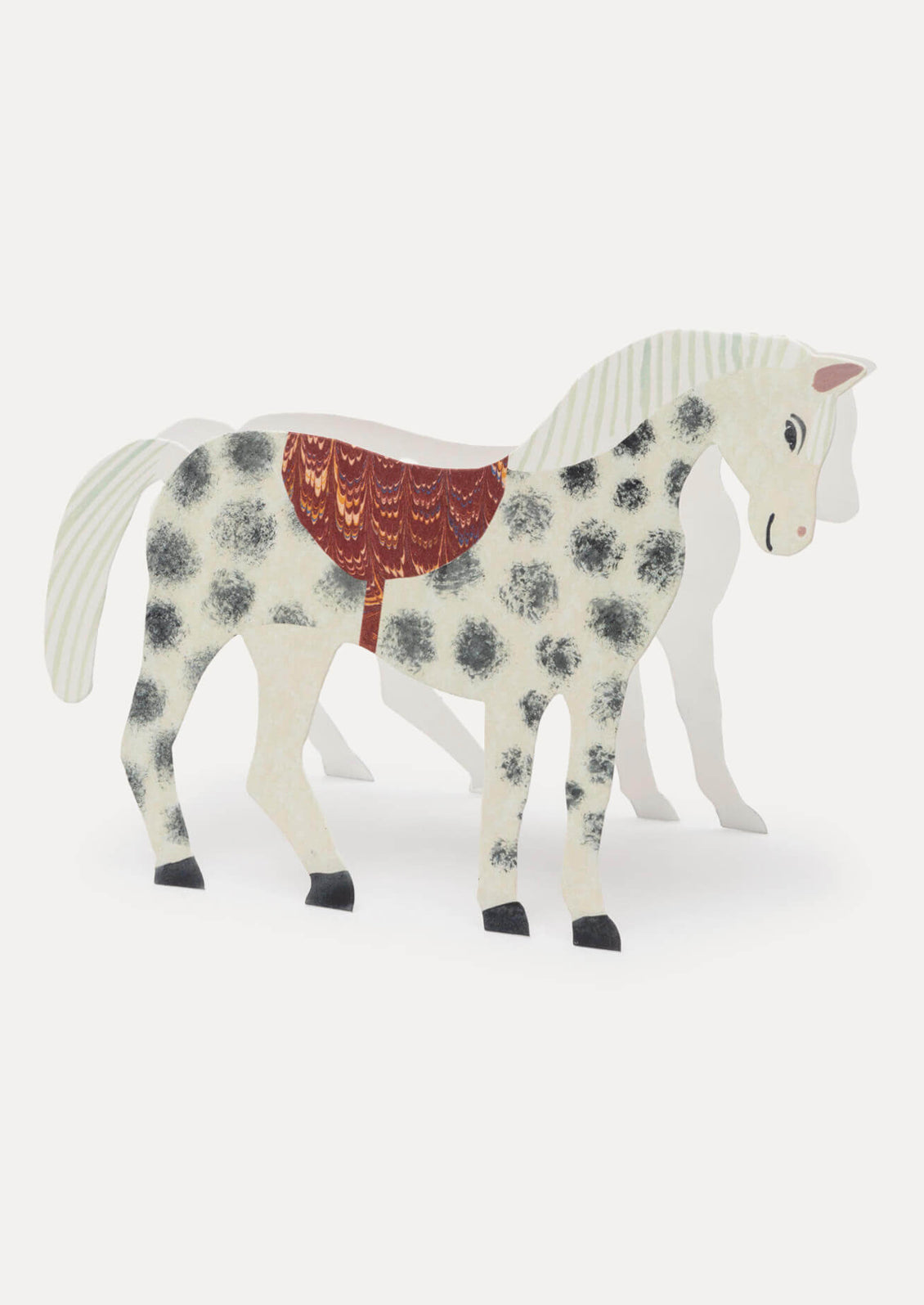 Decorative horse figurine with a floral pattern and red saddle on a white background