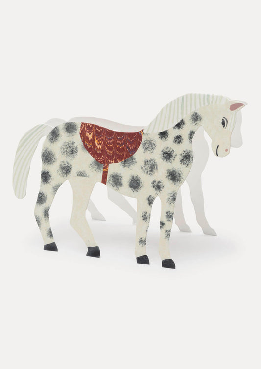 Decorative horse figurine with a floral pattern and red saddle on a white background