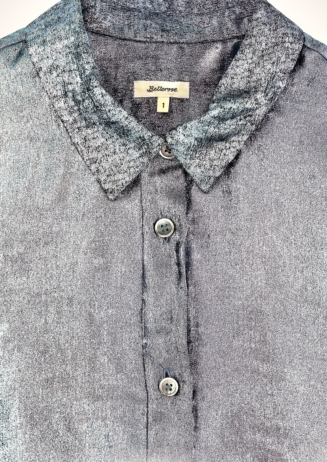 A metallic blue collared blouse.