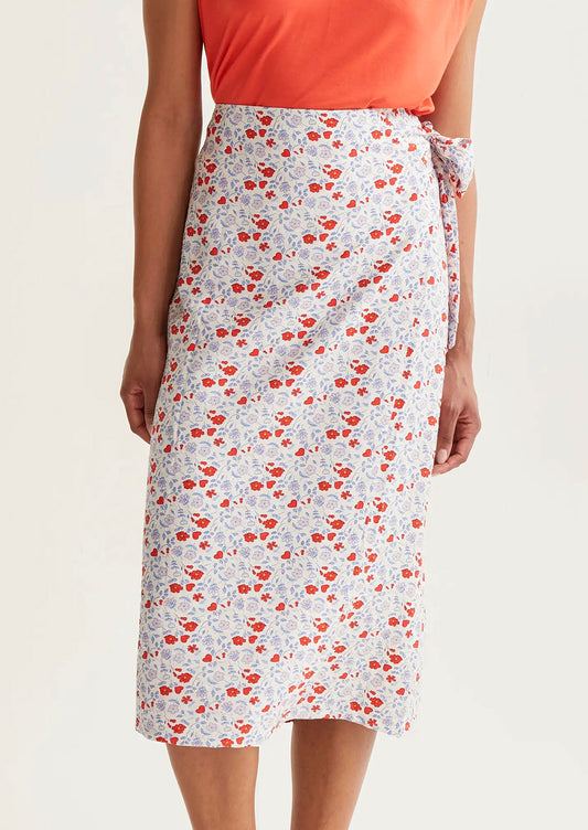 Floral skirt worn by a person on a plain background