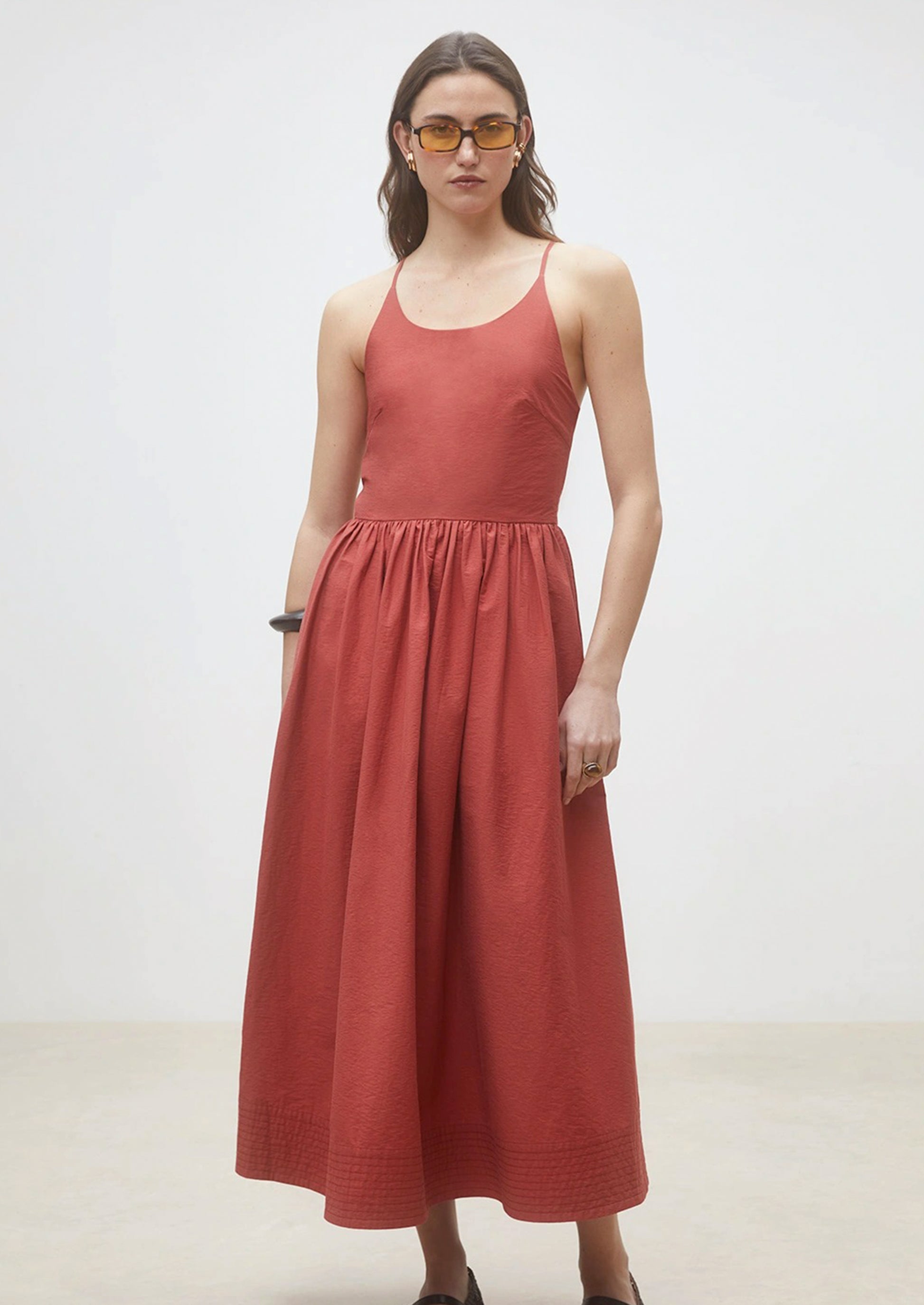 A person wearing a cross back dress.