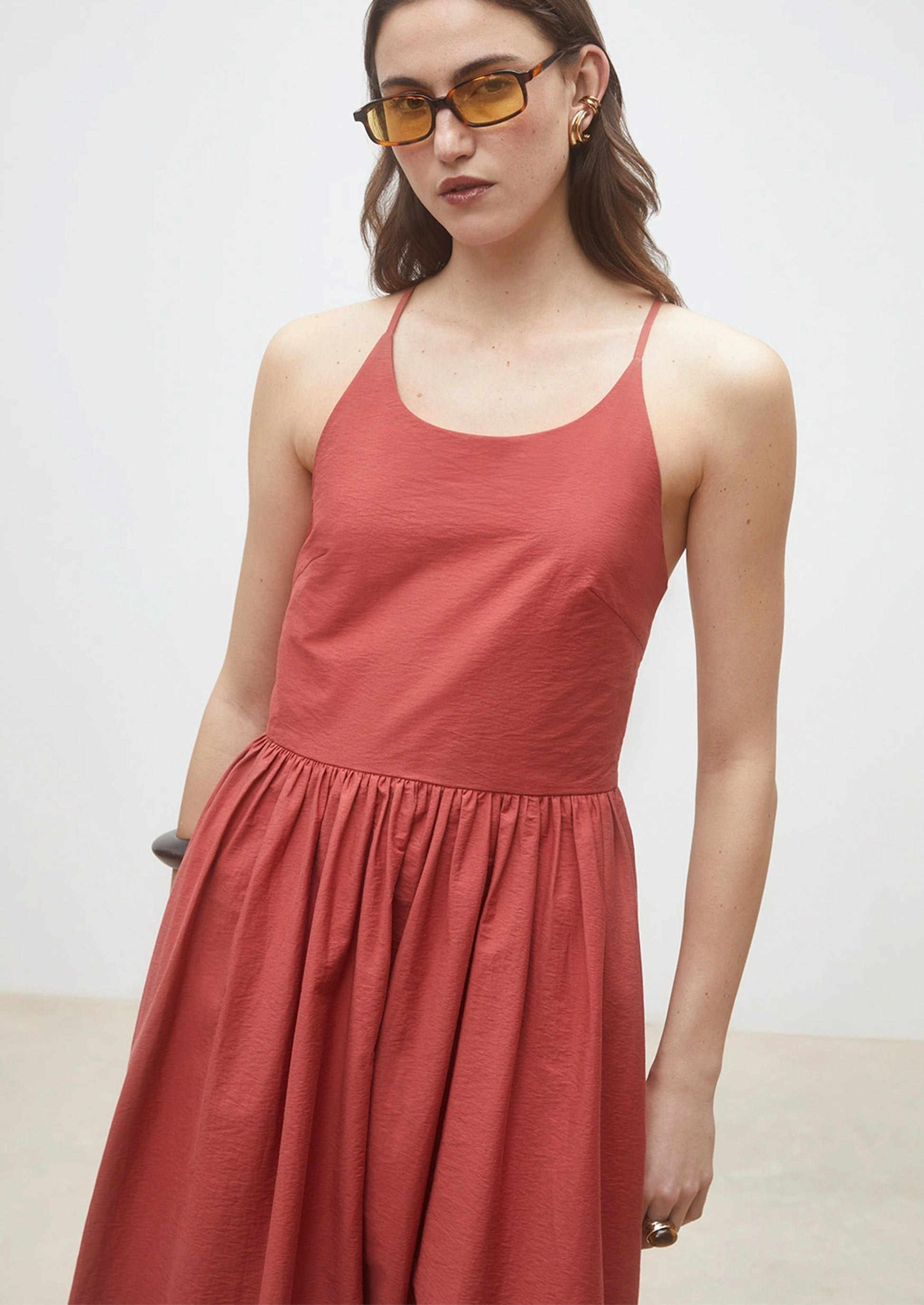 A person wearing a cross back dress.