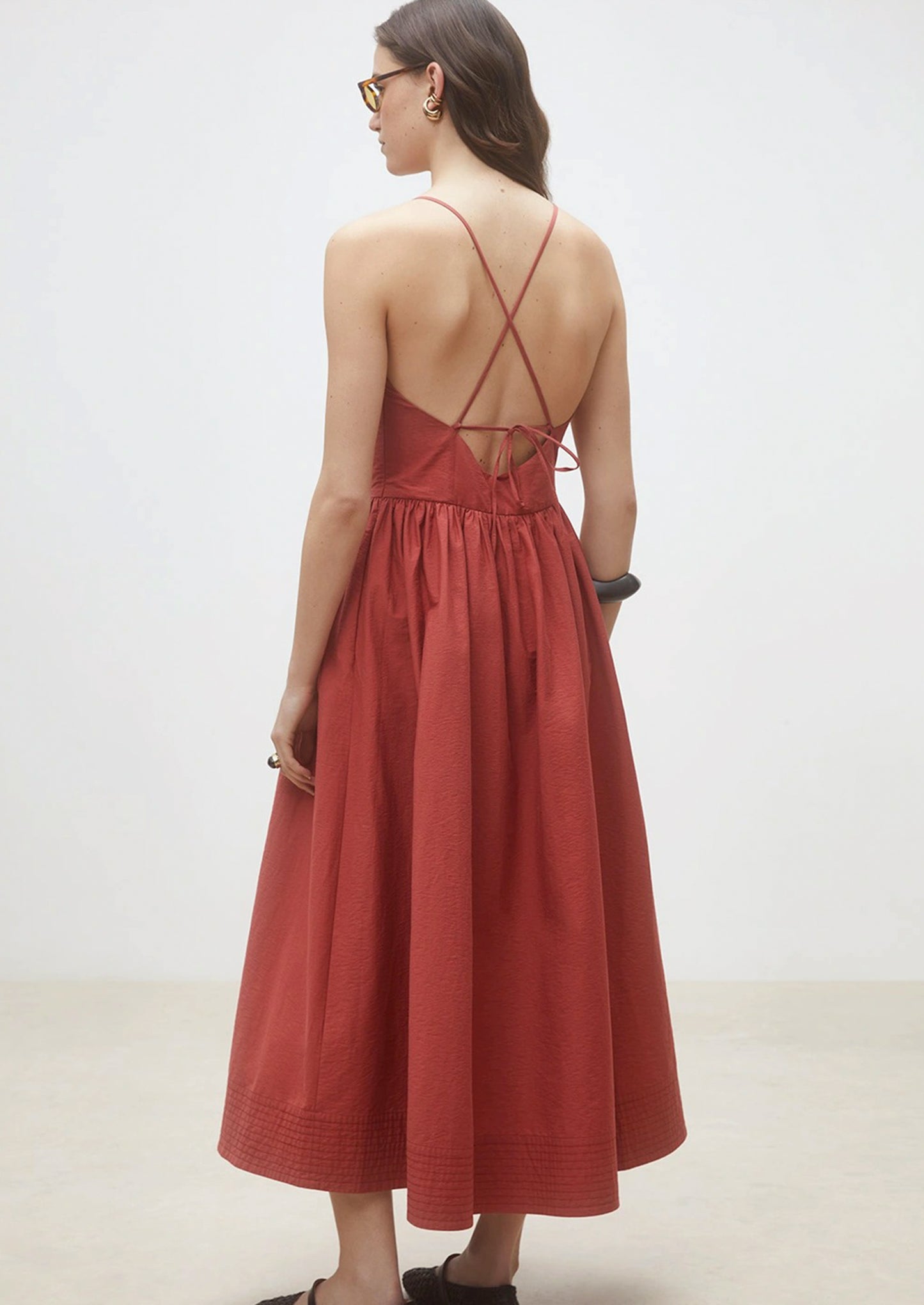 A person wearing a cross back dress.