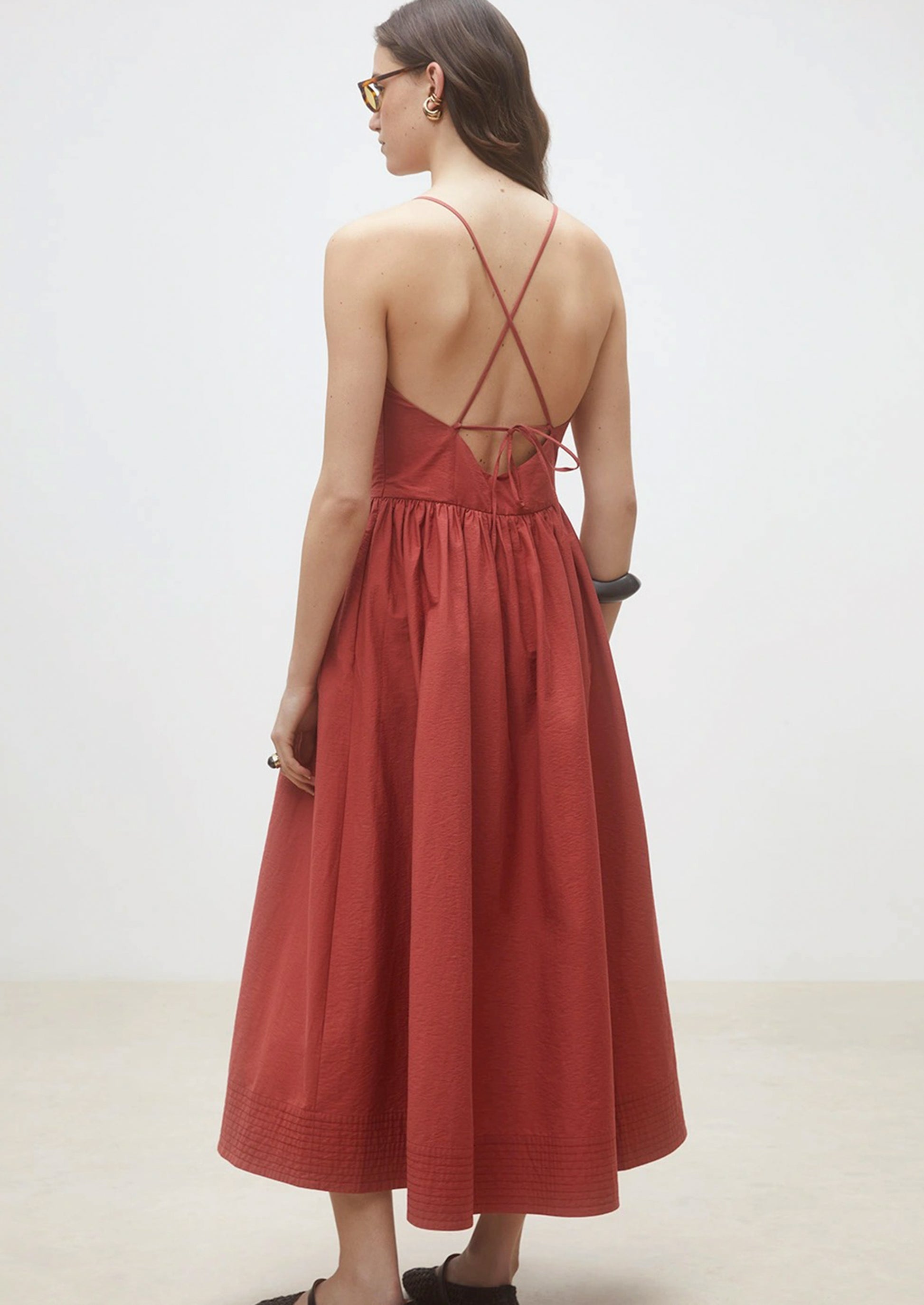 A person wearing a cross back dress.