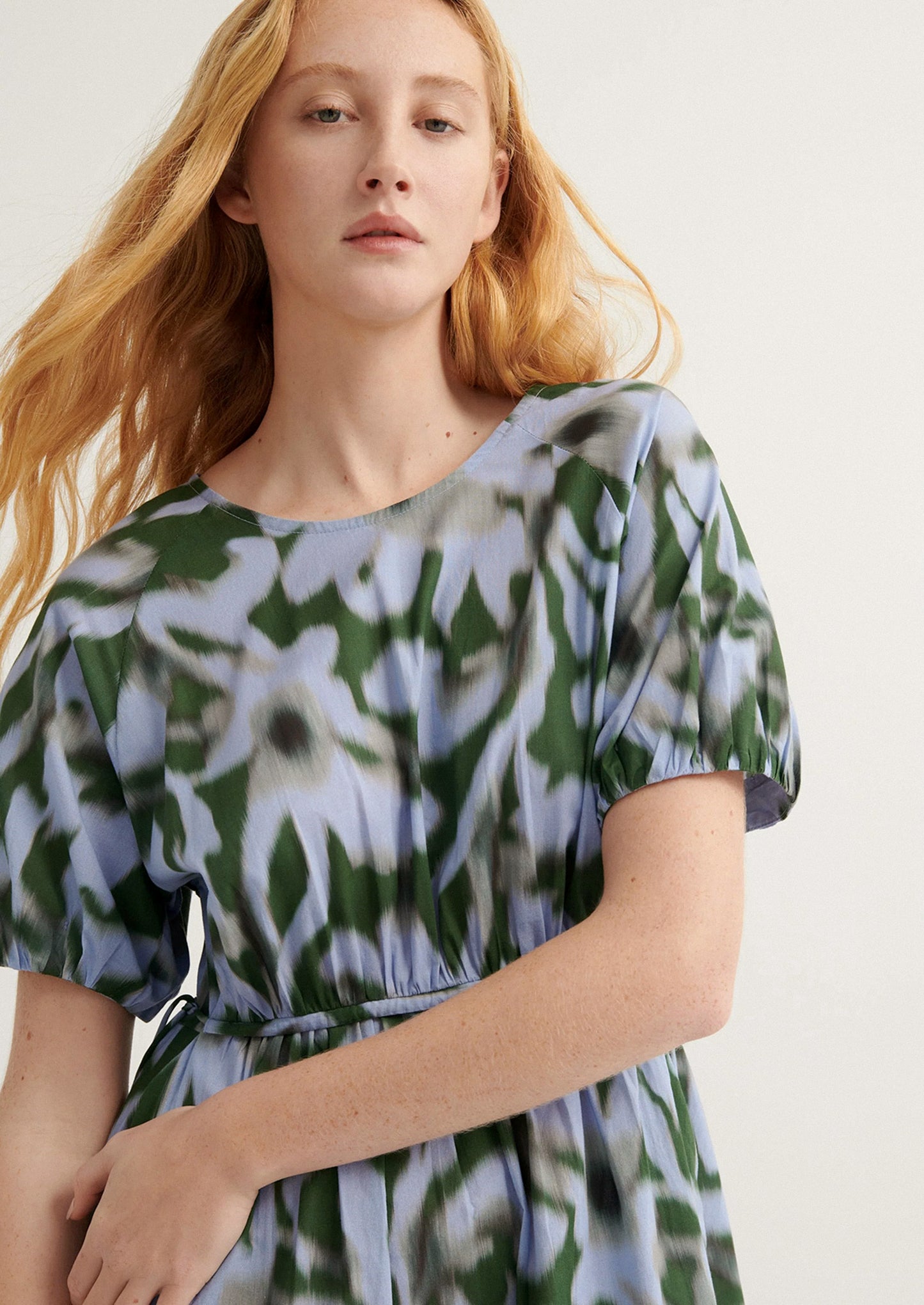 Woman wearing a floral dress with a white background