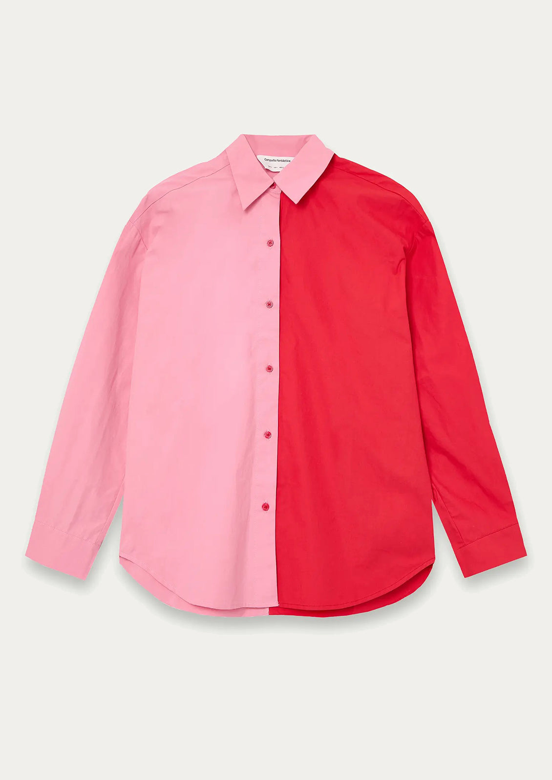 Color-blocked shirt with pink and red sections on a light gray background