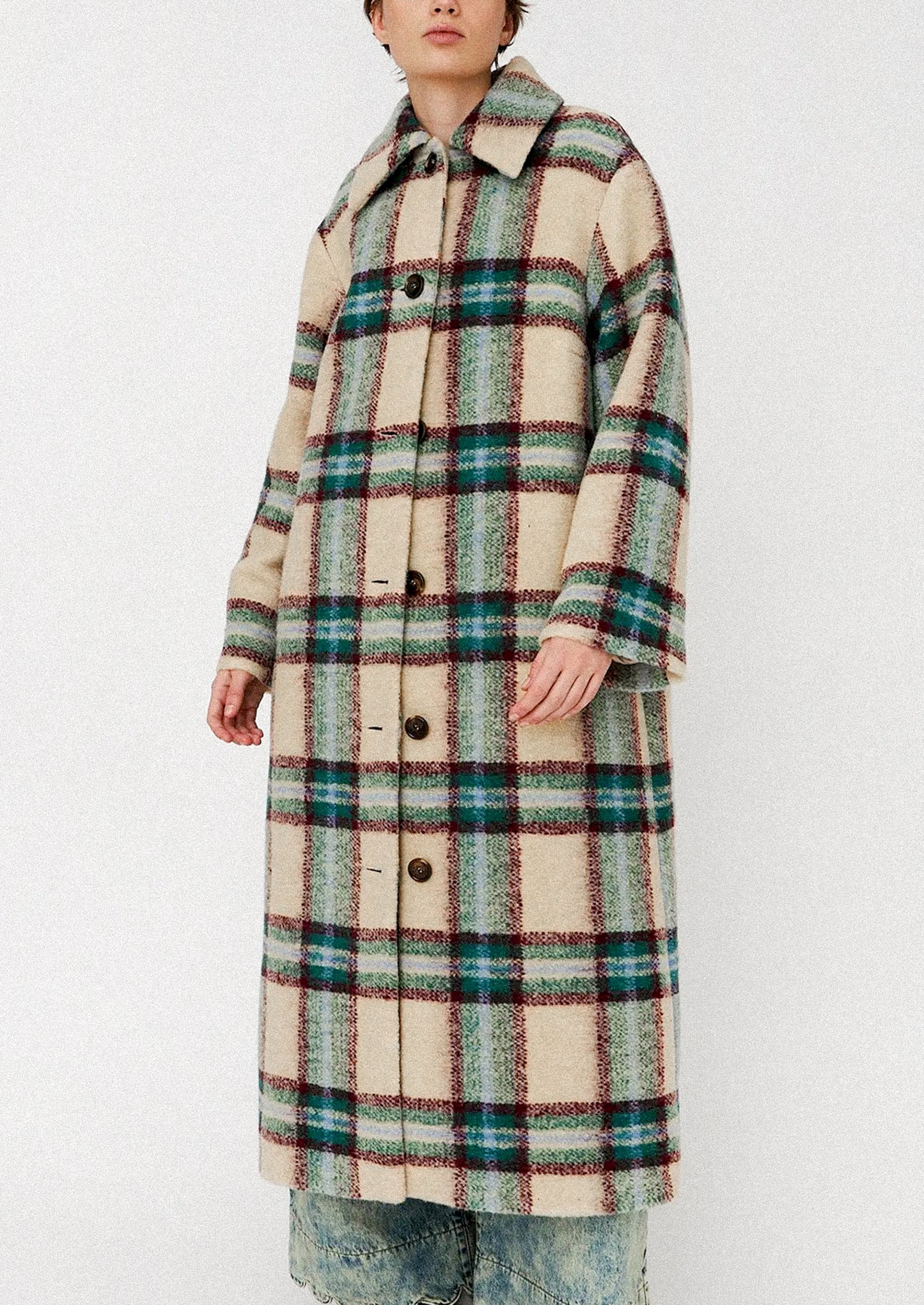 Person wearing a plaid coat on a white background