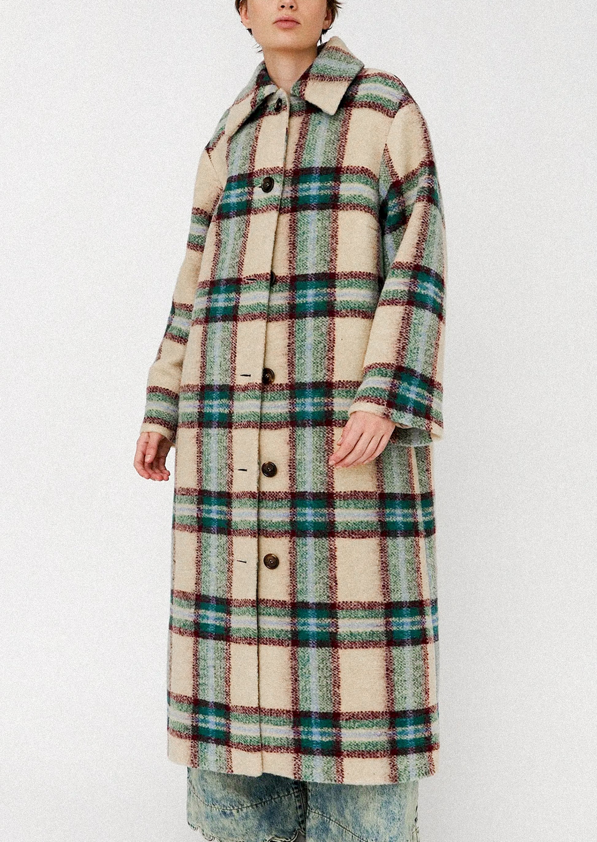 Person wearing a plaid coat on a white background