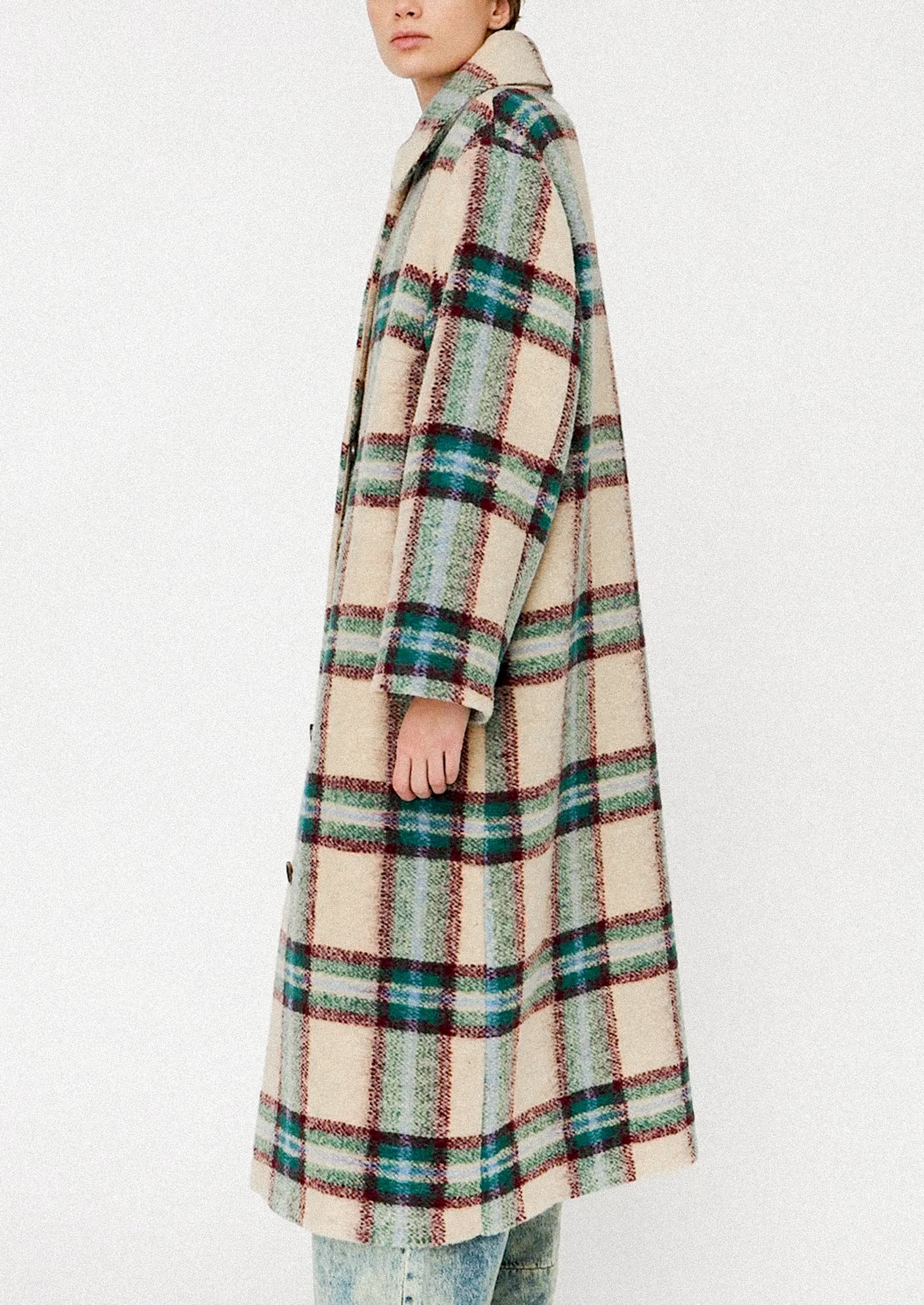 Plaid coat worn by a person on a white background