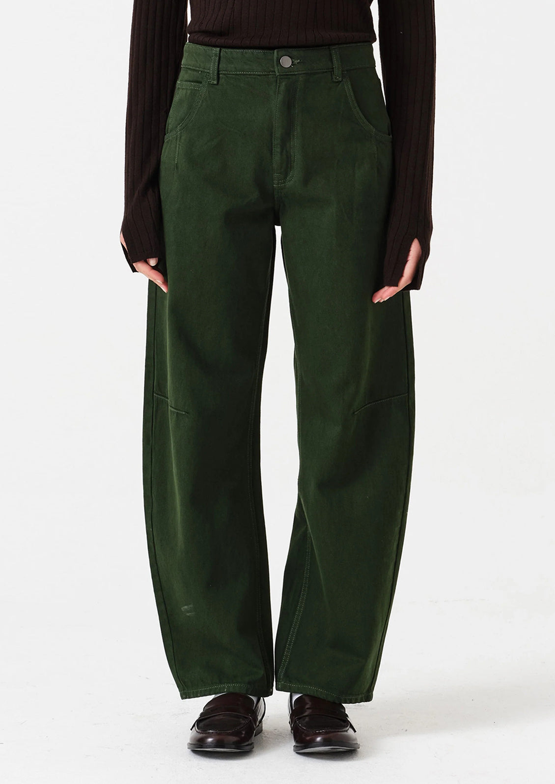Person wearing dark green pants on a white background