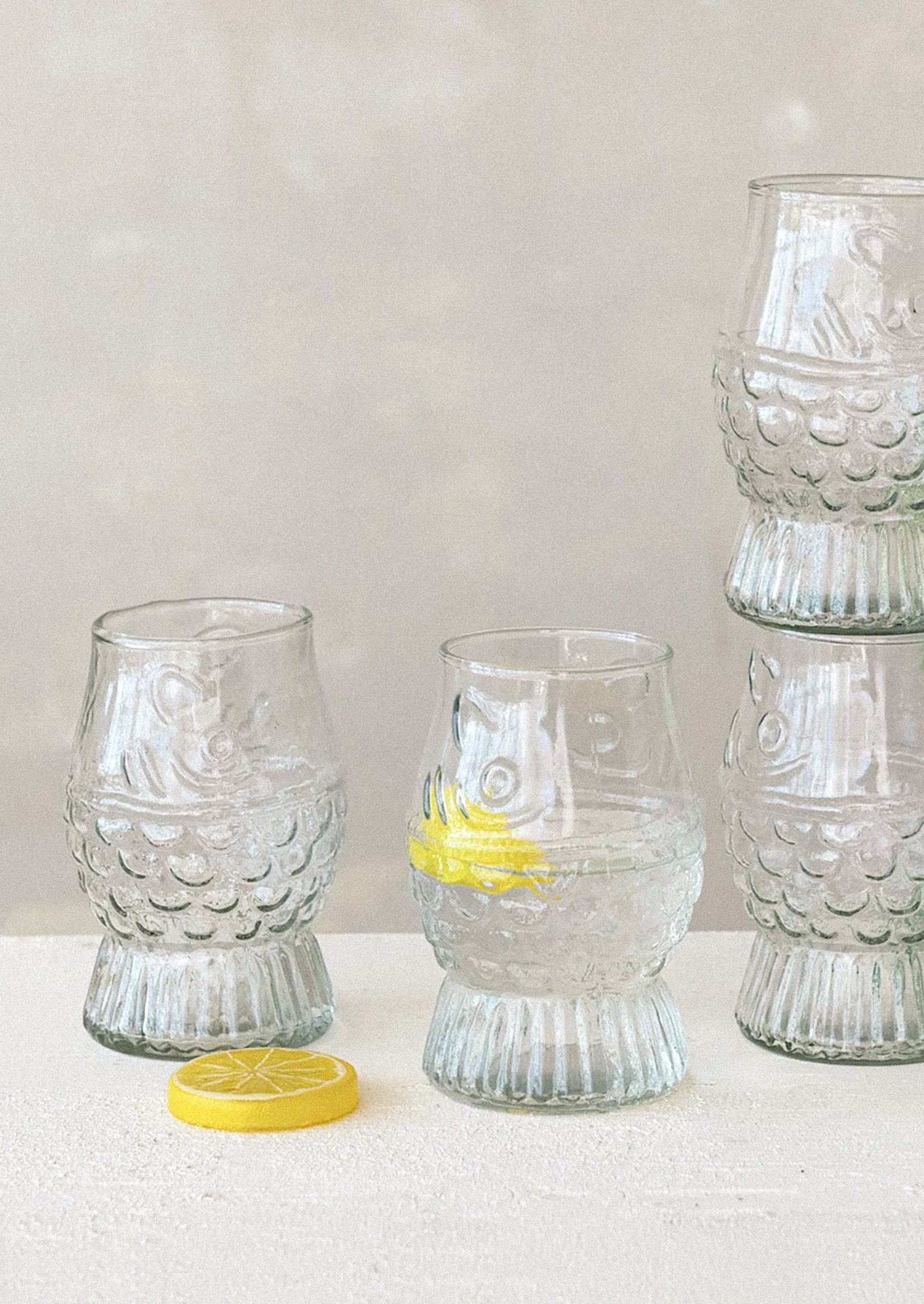 Clear glass tumblers with fish shape.