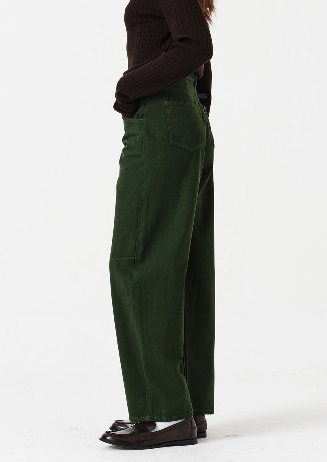 Green cargo pants worn by a person on a white background