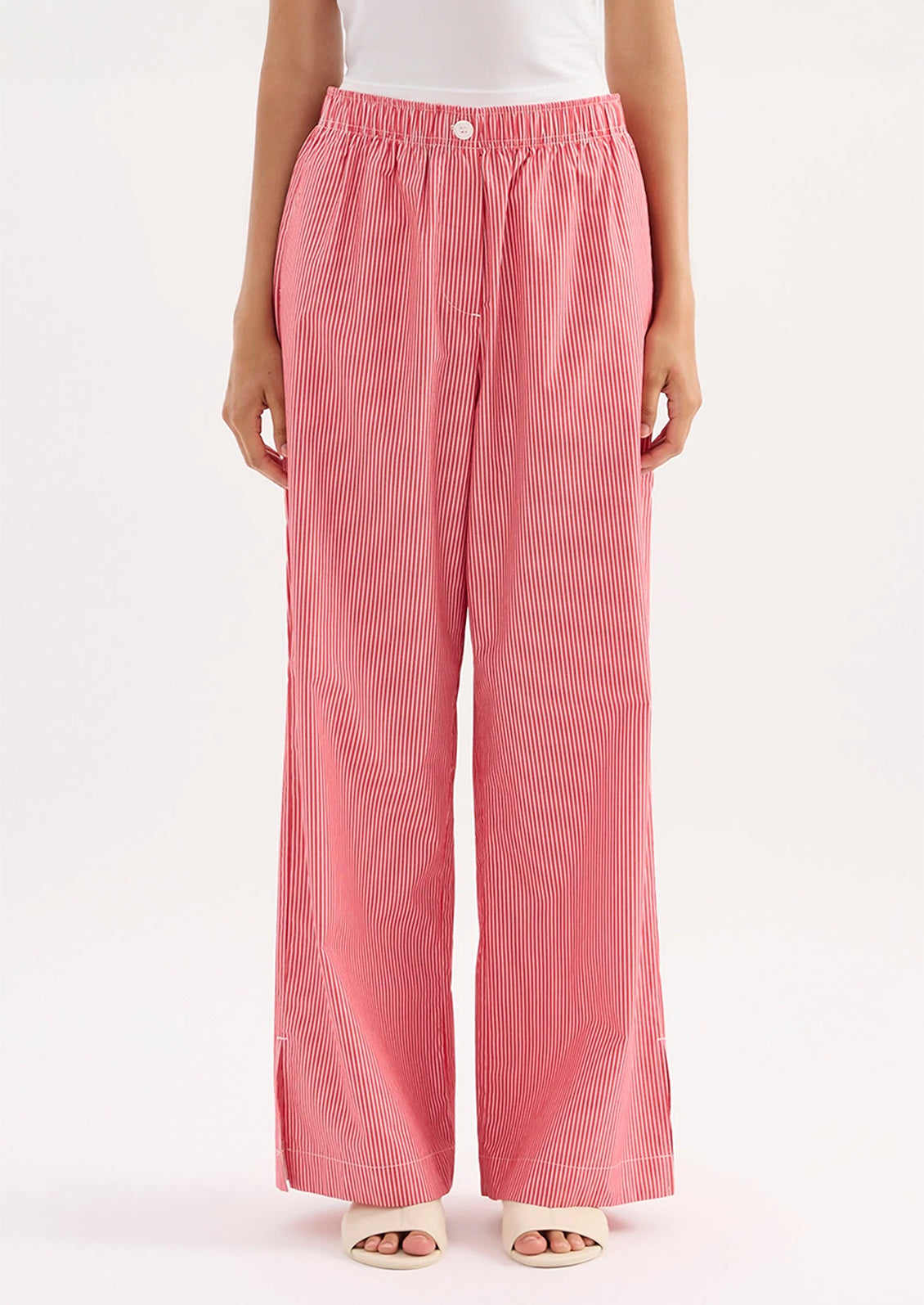 Person wearing red striped pants on a white background