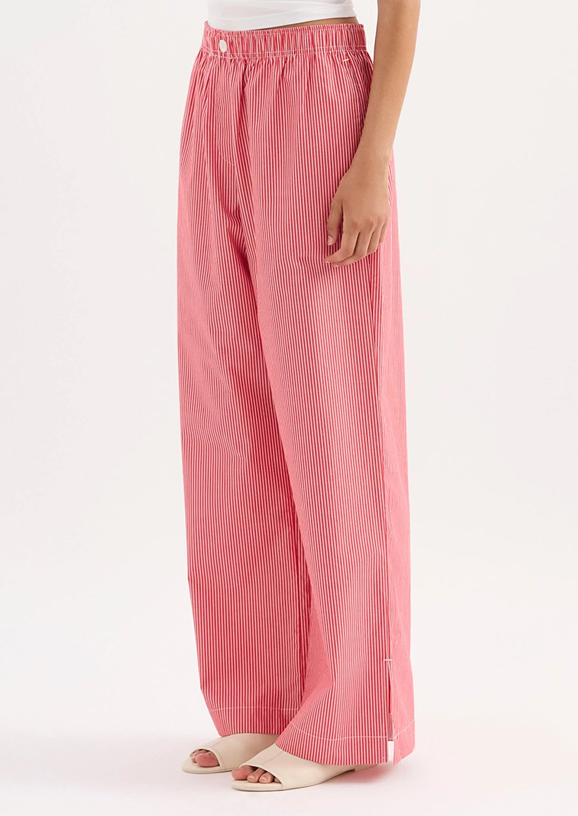 Red striped pants worn by a person on a white background