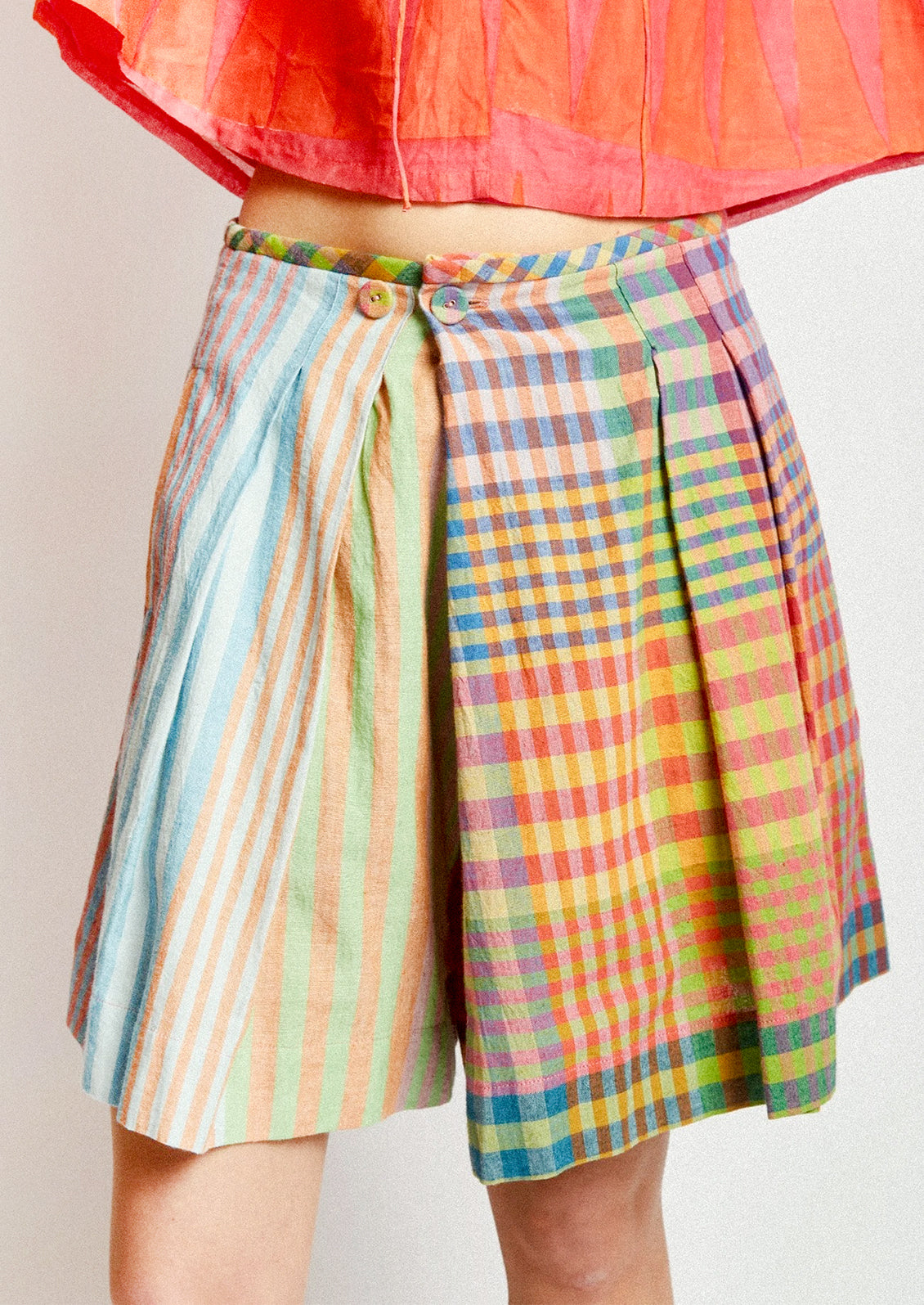 A person wearing a skort in colorful madras cotton.