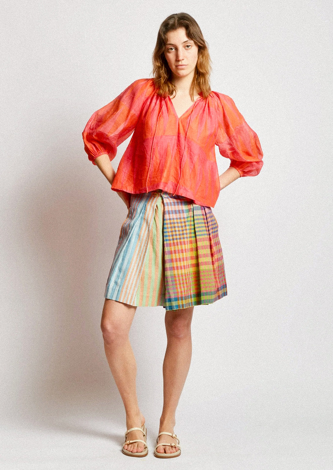 A person wearing a skort in colorful madras cotton.