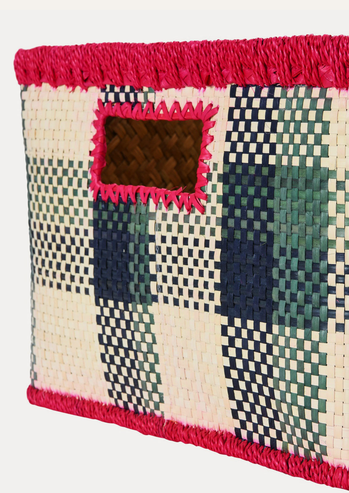 Woven basket with geometric pattern and pink trim on a white background