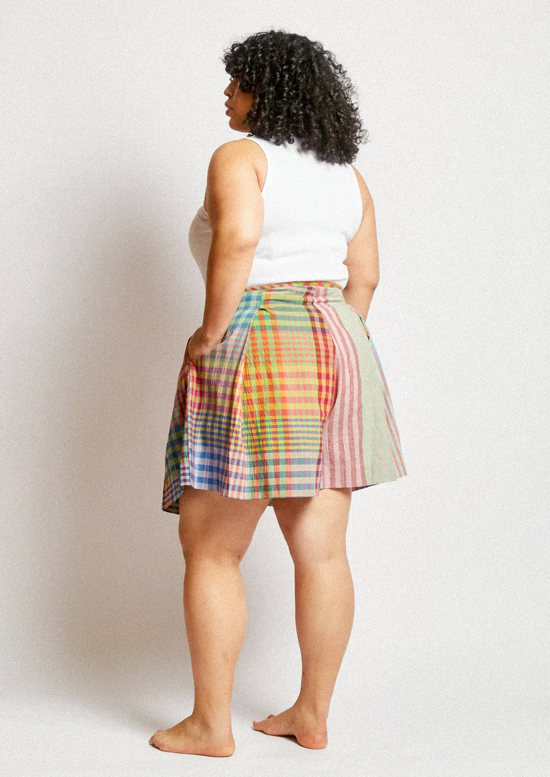 A person wearing a skort in colorful madras cotton.