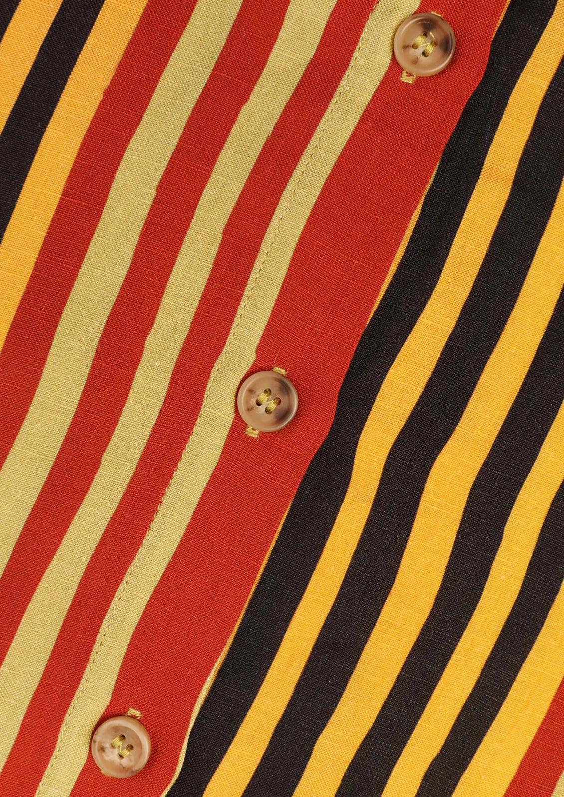 Close-up of a shirt with red, yellow, and black striped pattern and button details.