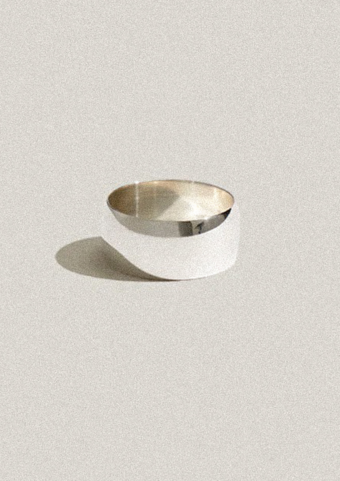 Silver ring on a light gray background