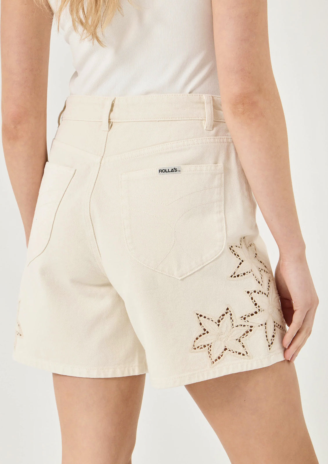 Beige shorts with star patterns on a plain background
