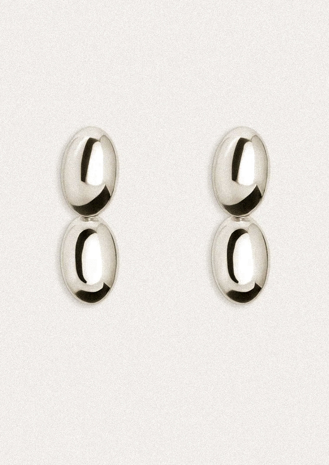 Pair of silver earrings on a white background