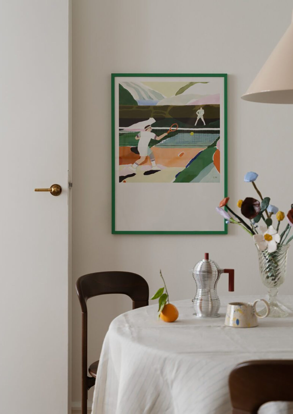 An art print of a painting of two people playing tennis amidst colorful scenery.