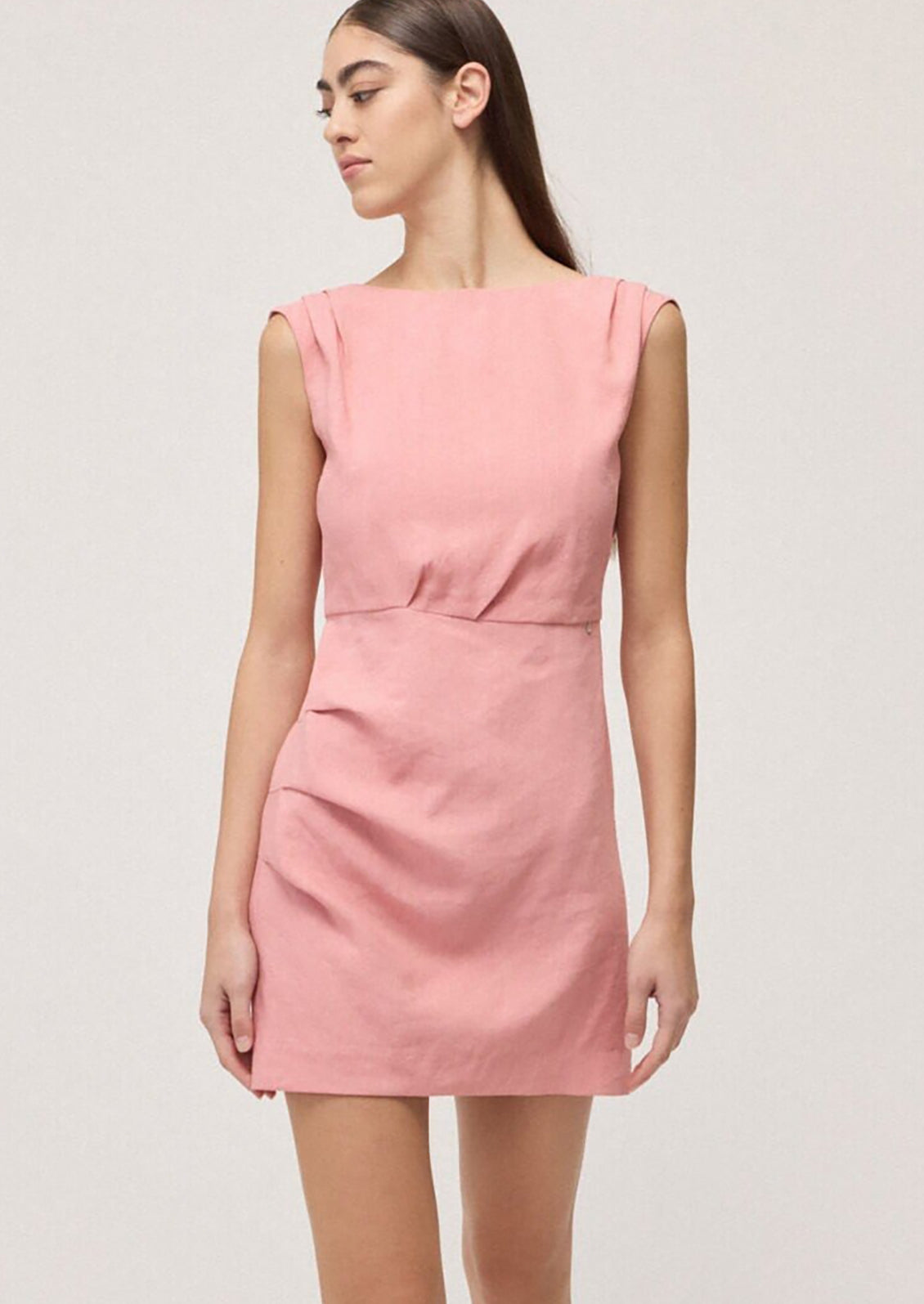 Pink dress worn by a model on a light gray background