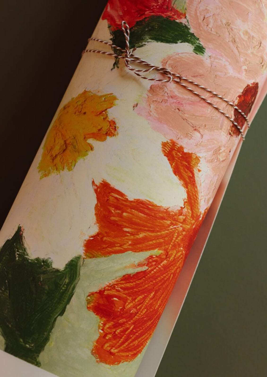 An art print of painterly flowers on a sage green background, bordered by cream.