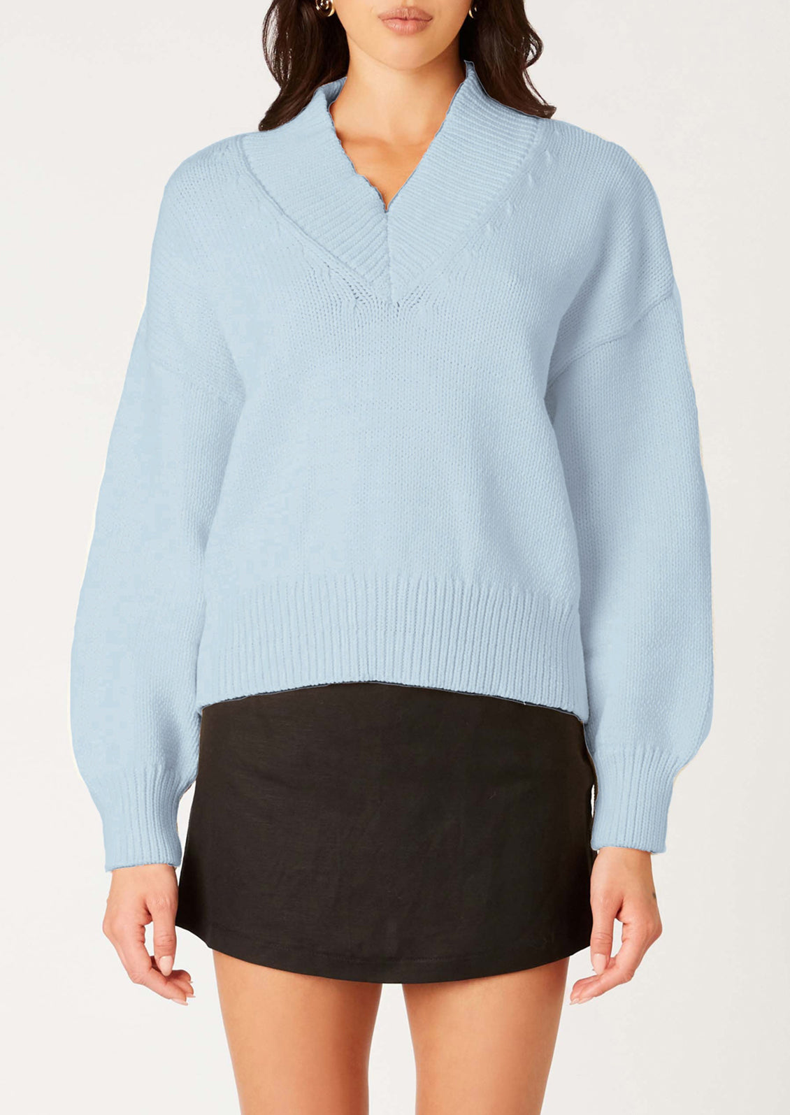 Light blue sweater worn by a person on a white background