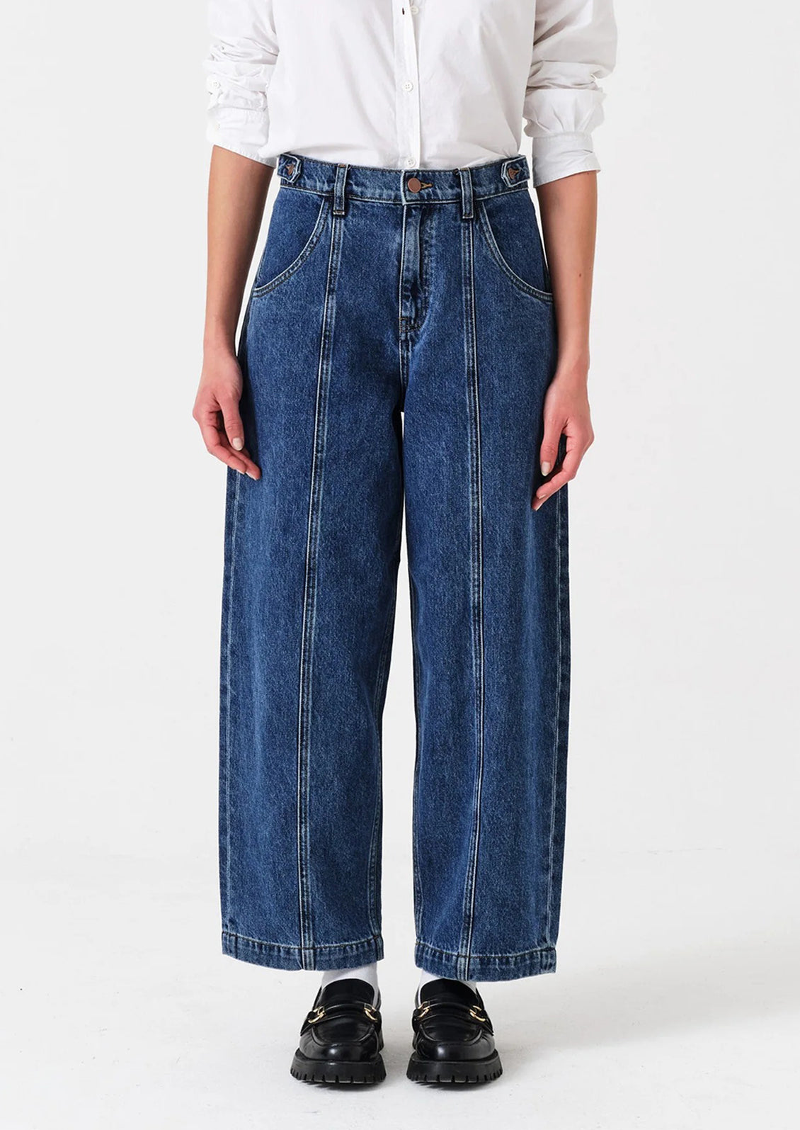 Person wearing blue jeans and a white shirt on a white background